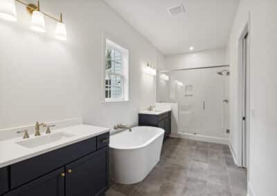Primary bathroom with dual vanities and soaking tub and walk in shower