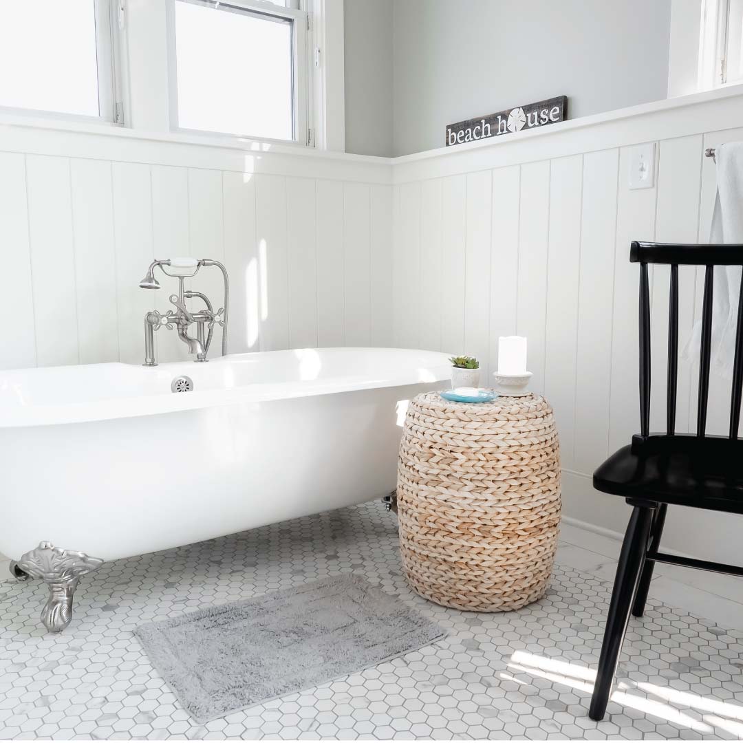 Claw tooth bathtub, chair, and windows in the Gailamas home's bathroom
