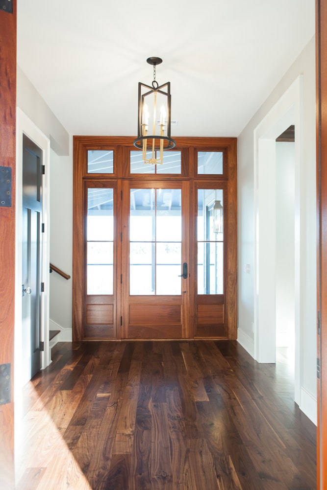 Bright wooden entryway door inside of custom Johns Island Home