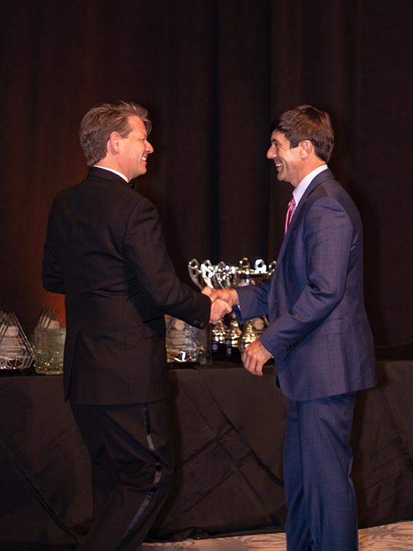 Brett and Grant shaking hands during the 2022 PRISM Awards