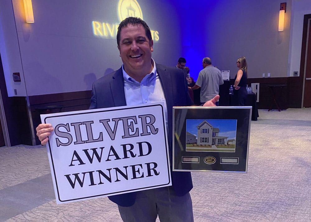 Alan Degen, division president of the Wilmington Division, accepts a Silver Award for the Gates model home during the 2023 Parade of Homes.