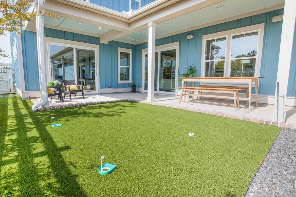 Synthetic turf with miniture golf course in courtyard home in Nexton